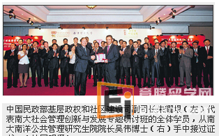 中国民政部基层政权和社区建设司副司长朱耀垠代表南大社会管理创新与发展专题研讨班的全体学员，从南大南洋公共管理研究生院院长吴伟博手中接过证书。
